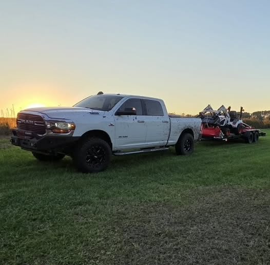 Compton Land Services pickup and tractor equipment parked on grass